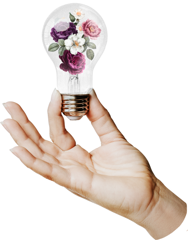 A hand holding a lightbulb with flowers inside of the bulb.